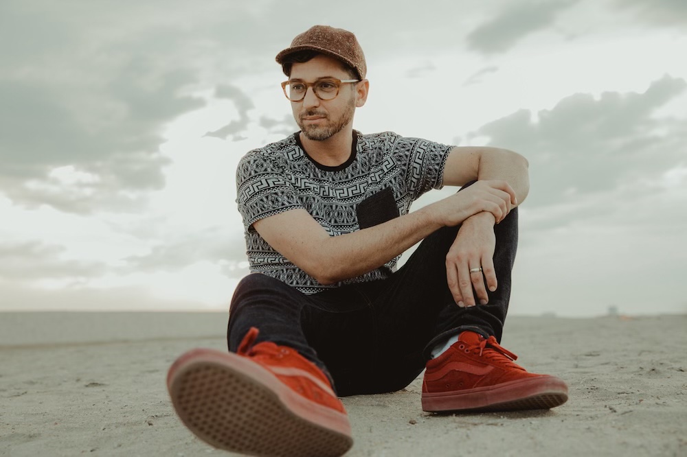 Trevor Davis seated outdoors near the San Diego coast