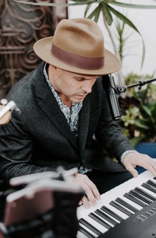 Eric performing outdoors at the keyboard