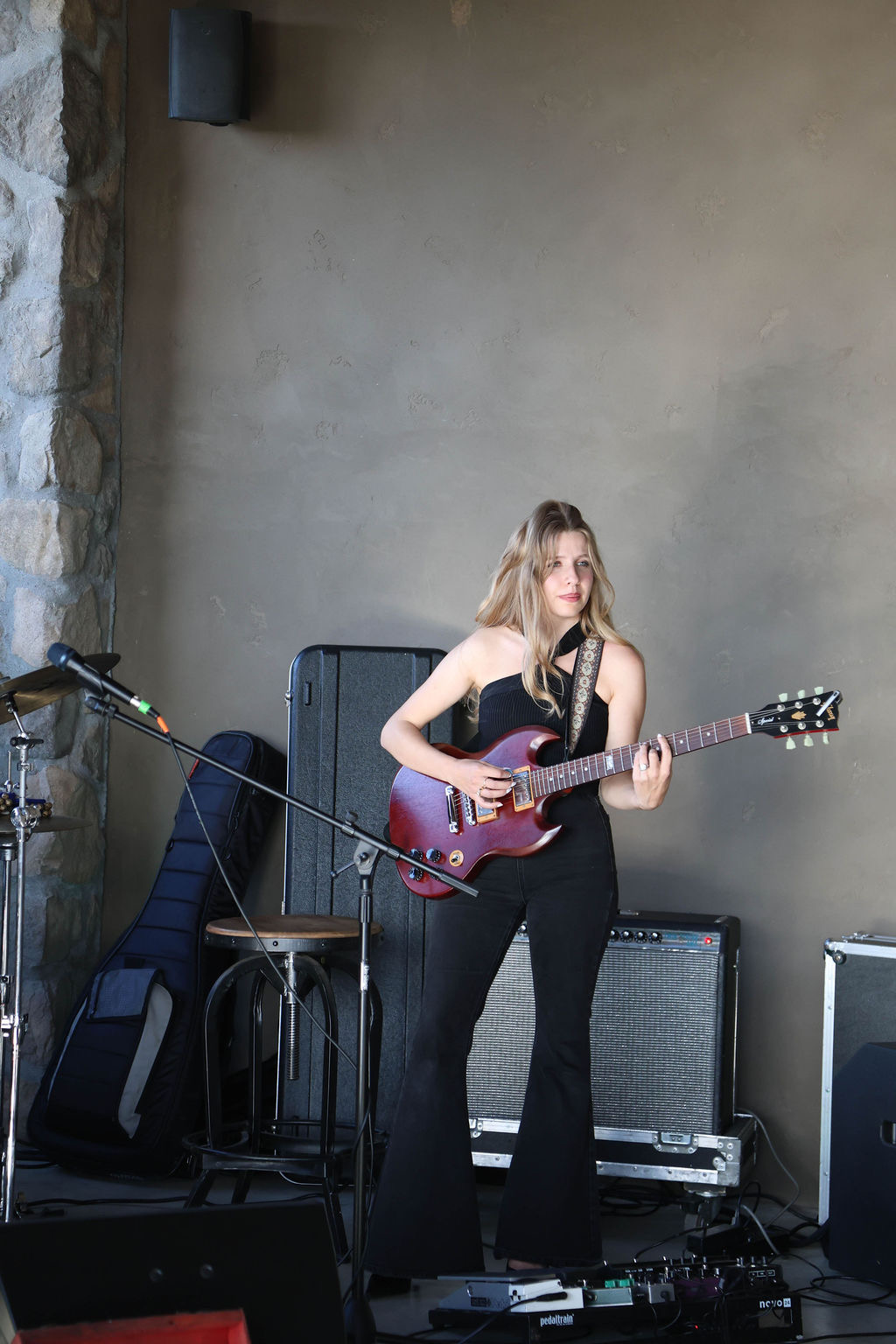 A Rowdy Band guitarist playing electric guitar on stage